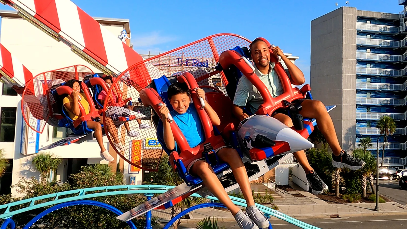People enjoying an outdoor amusement park ride